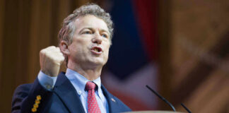 US Senator Rand Paul giving a passionate speech with fist raised.