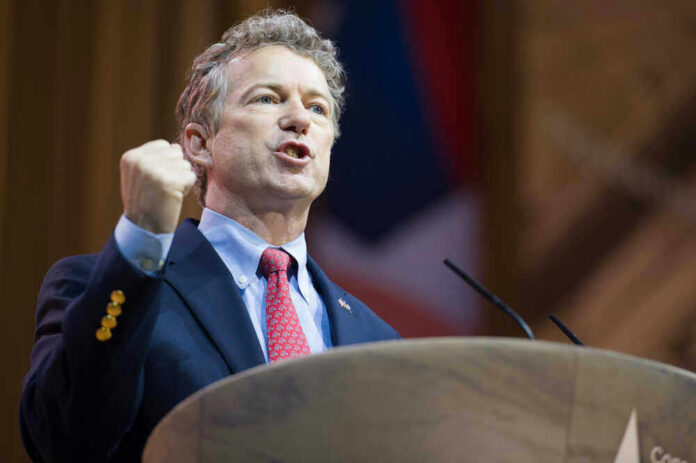 US Senator Rand Paul giving a passionate speech with fist raised.