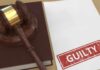 Guilty Words Jolt: State Case in Jeopardy Judge’s gavel on a book beside a paper stamped guilty