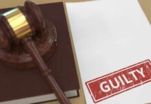 Judge’s gavel on a book beside a paper stamped guilty