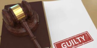 Judge’s gavel on a book beside a paper stamped guilty