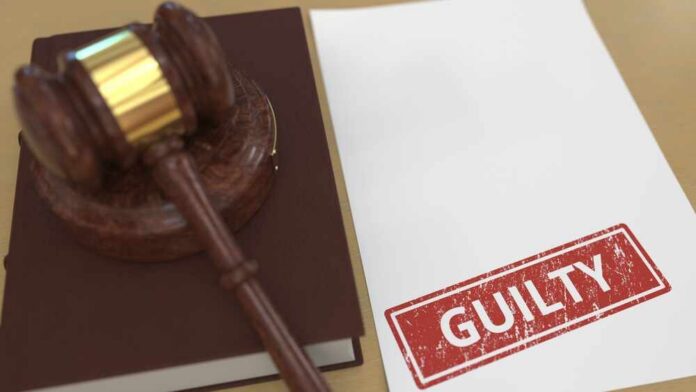 Judge’s gavel on a book beside a paper stamped guilty