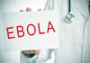 Doctor holding a sign about Ebola