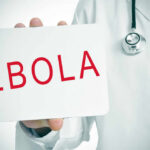 Doctor holding a sign about Ebola