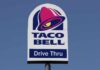 Taco Bell drive-thru sign against a clear blue sky