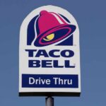Taco Bell drive-thru sign against a clear blue sky