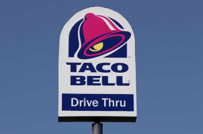 Taco Bell drive-thru sign against a clear blue sky
