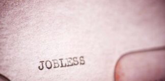 Close-up of a typewriter with the word 'JOBLESS' typed on paper