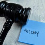 Judge's gavel resting on a blue sticky note