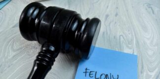 Judge's gavel resting on a blue sticky note