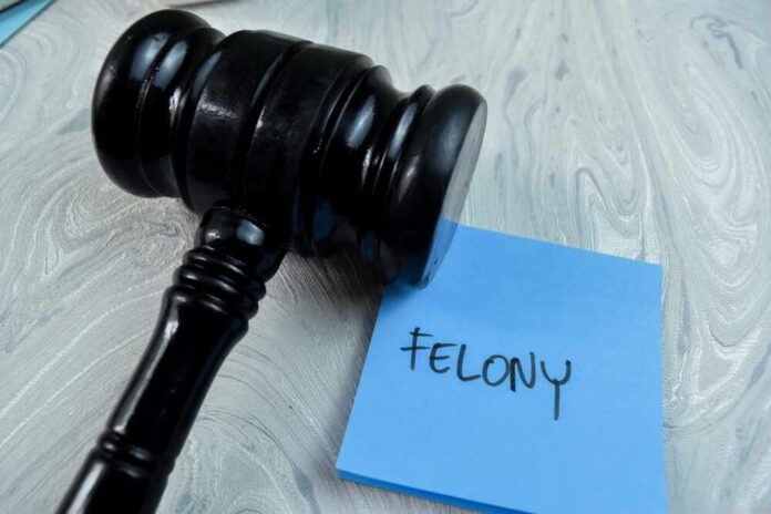 Judge's gavel resting on a blue sticky note