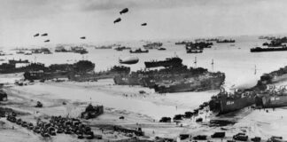 Allied landing on Normandy beach during D-Day, WWII.