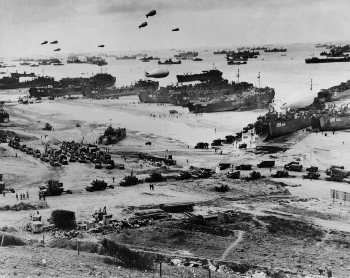 shutterstock_249573949-1 Allied landing on Normandy beach during D-Day, WWII.