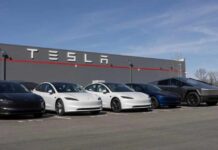 Tesla Slammed With MEGA Recall A lineup of Tesla cars parked in front of a Tesla building