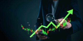 Business professional analyzing stock market trends with a magnifying glass