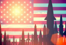 Missiles silhouetted against American flag background with sunset.