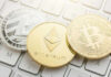 Litecoin, Ethereum, and Bitcoin coins on a keyboard.