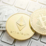 Litecoin, Ethereum, and Bitcoin coins on a keyboard.