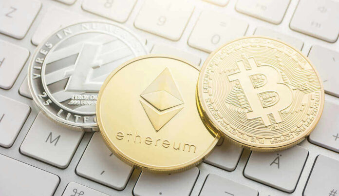 Litecoin, Ethereum, and Bitcoin coins on a keyboard.