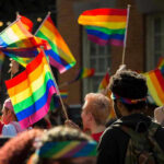 Hate Hit List Found After Tucson Killings People waving rainbow flags at a pride parade.