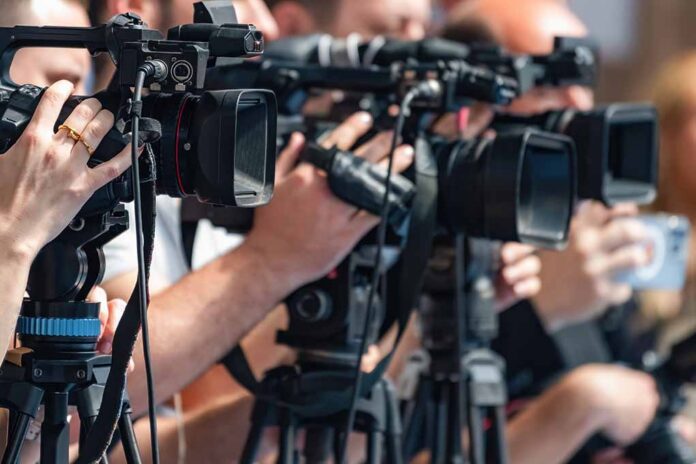 television cameras on tripods at a media event