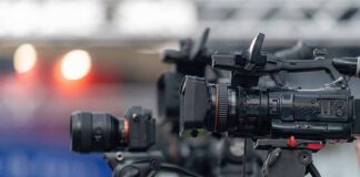 Professional video cameras on tripods