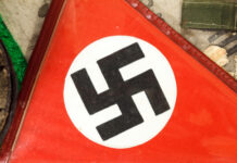Close-up of a red flag featuring a black swastika symbol