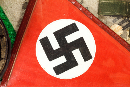 Close-up of a red flag featuring a black swastika symbol