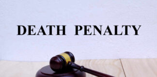 A wooden gavel resting on a block with the words 'DEATH PENALTY' in bold above it