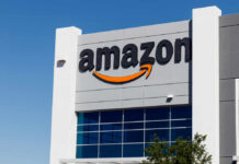Exterior view of an Amazon building with a prominent logo