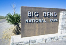 Big Bend National Park entrance sign beside a desert road