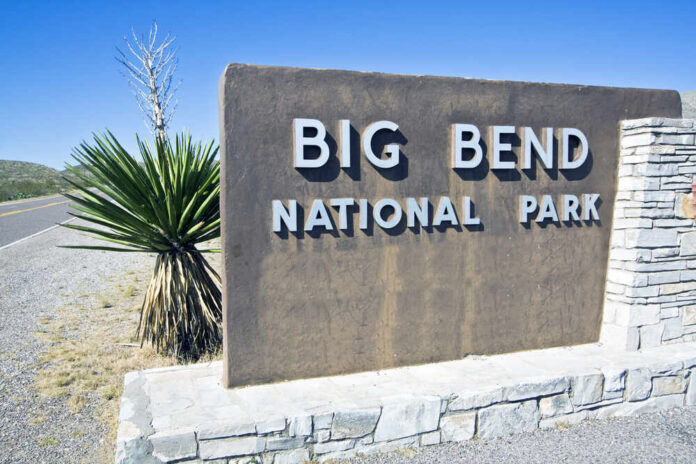 Big Bend National Park entrance sign beside a desert road