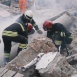 Rescue workers search rubble at a disaster site