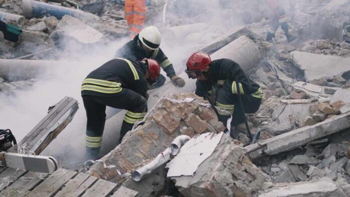 Rescue workers search rubble at a disaster site