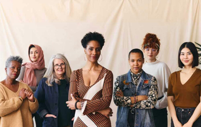 Group portrait of seven diverse women standing together