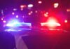 VIDEO: Mom Branded Abuser — For a Sidewalk Stroll? Police car with flashing red and blue lights at night