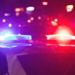 Police car with flashing red and blue lights at night