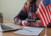 Permanent resident card and official letter on an American flag background