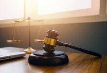 Retrial Whiplash, Big Name Falls Gavel and scales of justice on desk.