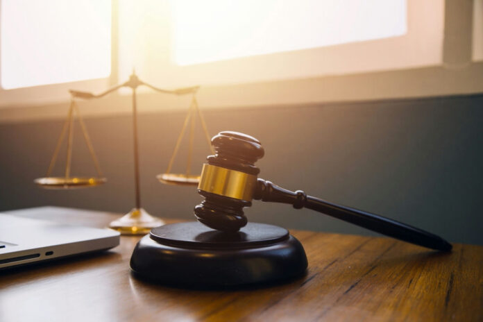 Gavel and scales of justice on desk.