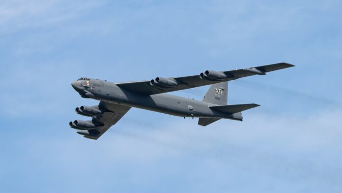 B-52 bomber flying against a blue sky