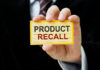 Hand holding a product recall card