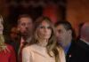Melania Trump at an event with a crowd in the background