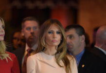 Melania’s Launch Shocks Wall Street Melania Trump at an event with a crowd in the background