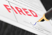 Fountain pen signing document with the word fired