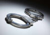 Close-up of metallic handcuffs on a light surface