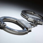 NEWS ALERT: 5-Year-Old Dead; Parents Arrested Close-up of metallic handcuffs on a light surface