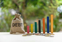 Debt sack with rising financial graph bars.
