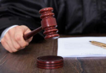 Barbacoa Shock: Jury Puts Price On Bite Judges hand holding gavel next to documents.