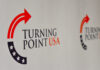 TPUSA Power Move BOMBSHELL Logo of Turning Point USA displayed on a backdrop